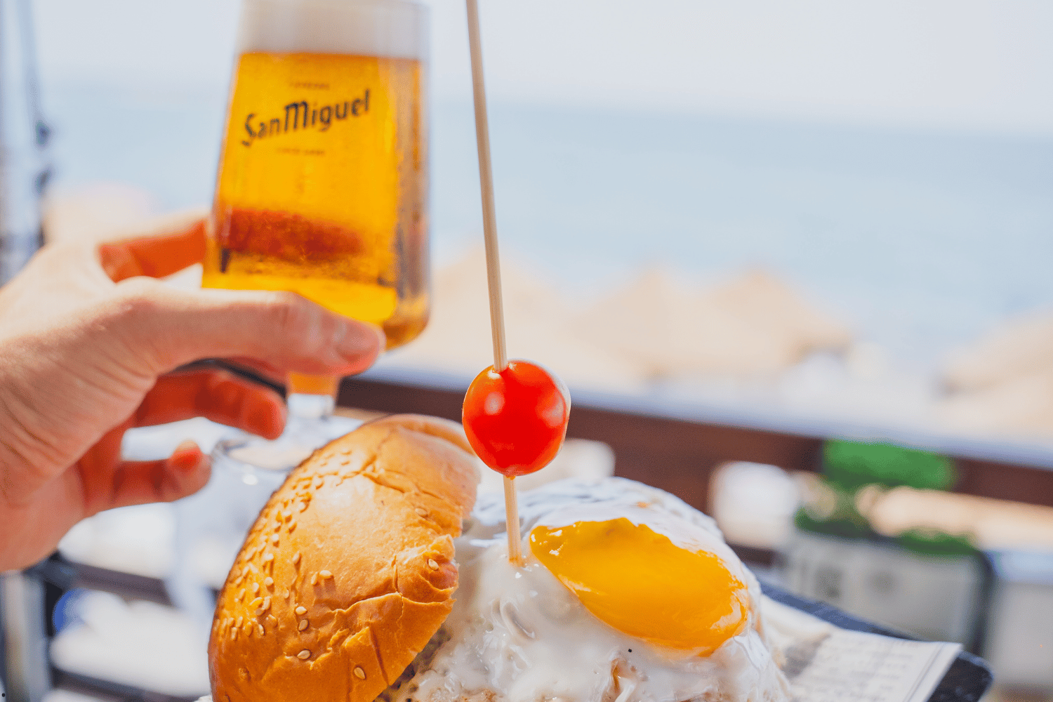 Vista nocturna de una fiesta en la terraza de Chiringuito Picasso con luces, música y gente celebrando junto a la playa en Málaga